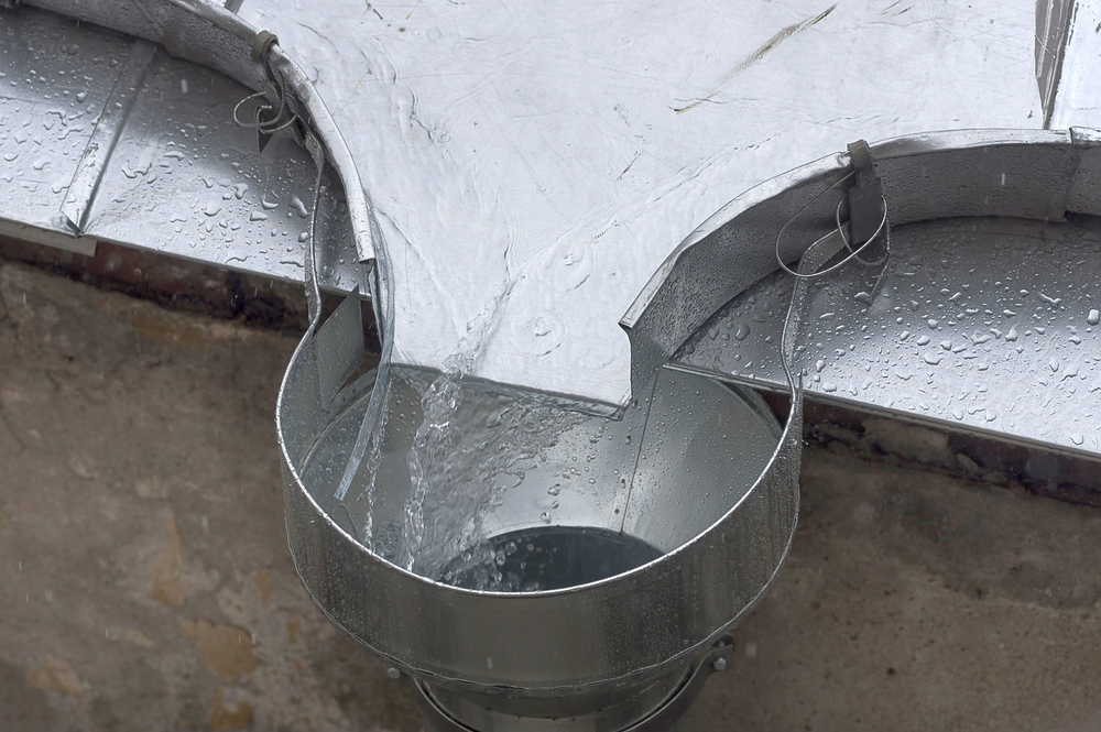 Rain,Water,Flows,Down,The,Roof,Into,The,Drain